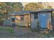 Rear view of home features a small outbuilding and overgrown yard at 414 E Wine St., Mullins, SC 29574