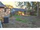 The backyard features an overgrown lawn and an external air conditioning unit at 414 E Wine St., Mullins, SC 29574