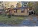 Modest single-story residence with a covered entrance and mature foliage creating privacy at 414 E Wine St., Mullins, SC 29574