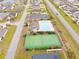 Aerial view showcasing community pool, tennis courts, clubhouse, and surrounding residential area at 424 Enderby Way, Little River, SC 29566