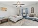 Cozy bedroom with two twin beds, neutral tones, ceiling fan, and ample natural light at 424 Enderby Way, Little River, SC 29566