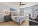 Comfortable bedroom with large window, ceiling fan, stylish bedding, and matching dressers at 424 Enderby Way, Little River, SC 29566