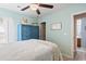Comfortable bedroom featuring a blue dresser, decorative baskets, ceiling fan, and access to a bathroom at 424 Enderby Way, Little River, SC 29566