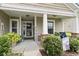 Charming front porch with decorative plants and wreath at 424 Enderby Way, Little River, SC 29566