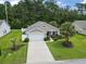 Inviting single-Gathering home with a large lawn, mature landscaping and a concrete driveway at 424 Enderby Way, Little River, SC 29566
