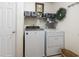 Bright laundry room featuring a washer and dryer, storage shelf, and decorative accents at 424 Enderby Way, Little River, SC 29566