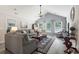 Bright living room with vaulted ceiling, comfortable sofas, and plenty of natural light from large windows at 424 Enderby Way, Little River, SC 29566