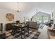 Open concept living and dining area boasts vaulted ceilings and natural light at 424 Enderby Way, Little River, SC 29566