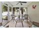 Enclosed sunroom featuring wicker seating, tile floors, ceiling fan and views of palm trees at 424 Enderby Way, Little River, SC 29566