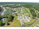 Enjoy an aerial view of the community, featuring a golf course, pond, and a variety of home styles at 439 Colonial Trace Dr. # 119, Longs, SC 29568