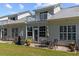 The backyard features a patio area with table and chairs, plus a grill, great for outdoor entertaining at 439 Colonial Trace Dr. # 119, Longs, SC 29568