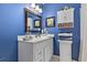 Stylish bathroom with white vanity, blue walls, decorative lighting, and modern fixtures at 439 Colonial Trace Dr. # 119, Longs, SC 29568