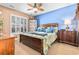 Comfortable bedroom featuring a wooden bed frame, blue accent wall, and ample natural light from the window at 439 Colonial Trace Dr. # 119, Longs, SC 29568
