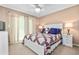 Bright bedroom features a bed with a colorful quilt, matching pillows, and bedside tables with lamps at 439 Colonial Trace Dr. # 119, Longs, SC 29568