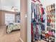 Walk-in closet featuring ample storage for hanging clothes, folded garments and shoe shelves next to primary bedroom at 439 Colonial Trace Dr. # 119, Longs, SC 29568