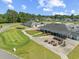 This is a detailed view of the clubhouse, complete with outdoor seating, putting green, and parking at 439 Colonial Trace Dr. # 119, Longs, SC 29568