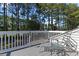 Outdoor deck with chairs and a small table, perfect for enjoying a relaxing time in the backyard at 439 Colonial Trace Dr. # 119, Longs, SC 29568