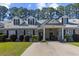 Charming home exterior boasting a well-manicured lawn and covered front porch, offering curb appeal and inviting entry at 439 Colonial Trace Dr. # 119, Longs, SC 29568