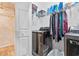 Convenient laundry room with modern washer and dryer, shelving for storage, and tile floor at 439 Colonial Trace Dr. # 119, Longs, SC 29568