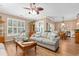 Bright living room with hardwood floors, comfortable seating, and large windows providing ample natural light at 439 Colonial Trace Dr. # 119, Longs, SC 29568