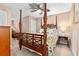 Elegant bedroom featuring a four-poster bed, ceiling fan, and soft natural light at 439 Colonial Trace Dr. # 119, Longs, SC 29568