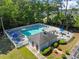 A refreshing community pool is surrounded by a white fence, lounge chairs, and lush greenery at 439 Colonial Trace Dr. # 119, Longs, SC 29568
