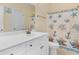 Bathroom featuring a white vanity with nautical-themed shower curtain and decorative mirror at 4413 Plantation Harbour Dr. # A, Little River, SC 29566