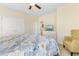 Bedroom with a TV, dresser, closet and an upholstered yellow arm chair for relaxation and comfort at 4413 Plantation Harbour Dr. # A, Little River, SC 29566