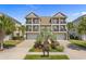 Charming two-story townhome featuring double balconies, lush landscaping and garage at 4413 Plantation Harbour Dr. # A, Little River, SC 29566