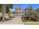 Beautiful two-story home with dual balconies, a well-manicured lawn, and a spacious driveway at 4413 Plantation Harbour Dr. # A, Little River, SC 29566