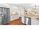 Bright kitchen features white cabinets, stainless steel appliances and hardwood floors at 4413 Plantation Harbour Dr. # A, Little River, SC 29566