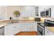 Bright kitchen features white cabinets, stainless steel appliances and hardwood floors at 4413 Plantation Harbour Dr. # A, Little River, SC 29566