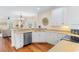 Bright kitchen features white cabinets, stainless steel appliances and hardwood floors at 4413 Plantation Harbour Dr. # A, Little River, SC 29566
