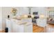 Bright kitchen features white cabinets, stainless steel appliances and hardwood floors at 4413 Plantation Harbour Dr. # A, Little River, SC 29566