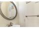 Close-up of a powder room featuring an oval mirror and a brushed nickel faucet at 4413 Plantation Harbour Dr. # A, Little River, SC 29566