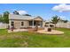 Landscaped backyard with a fire pit, BBQ area, storage shed, and green lawn at 4419 Kinlaw St., Little River, SC 29566