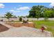 Beautifully landscaped backyard featuring a paver patio, fire pit, garden beds, and lawn at 4419 Kinlaw St., Little River, SC 29566