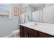 Well-lit bathroom with a white sink, wood cabinets, and decorative seashell accents at 4419 Kinlaw St., Little River, SC 29566