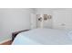 Cozy bedroom featuring a light blue quilt, hardwood floors, and white closet doors at 4419 Kinlaw St., Little River, SC 29566