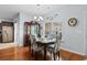 Dining room features a hardwood floor, dark wooden table and chairs and a china cabinet at 4419 Kinlaw St., Little River, SC 29566