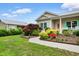 Beautiful home exterior with manicured landscaping, blue shutters, and a well-kept lawn at 4419 Kinlaw St., Little River, SC 29566