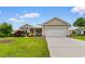 Charming single-story home features a 2-car garage, well-manicured lawn, and colorful landscaping at 4419 Kinlaw St., Little River, SC 29566