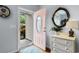 Foyer view with natural light, decorative mirror and white dresser at 4419 Kinlaw St., Little River, SC 29566
