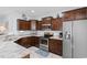 Modern kitchen boasts dark wood cabinetry, granite countertops, and stainless steel appliances at 4419 Kinlaw St., Little River, SC 29566