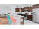 Well-equipped kitchen features granite countertops, stainless steel appliances, and dark wood cabinets at 4419 Kinlaw St., Little River, SC 29566