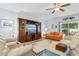 Spacious living room features a ceiling fan, plush seating, and decorative built-ins at 4419 Kinlaw St., Little River, SC 29566