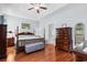 Large main bedroom with tray ceilings, hardwood floors, and an ensuite bathroom at 4419 Kinlaw St., Little River, SC 29566