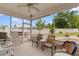 Inviting screened porch with outdoor furniture and views of the fenced backyard at 4419 Kinlaw St., Little River, SC 29566