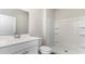 Bright bathroom featuring a white single sink vanity and a shower with built-in shelves at 442 Acosta Circle, Conway, SC 29527