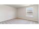 A cozy bedroom with neutral carpeting and natural light from a window at 442 Acosta Circle, Conway, SC 29527